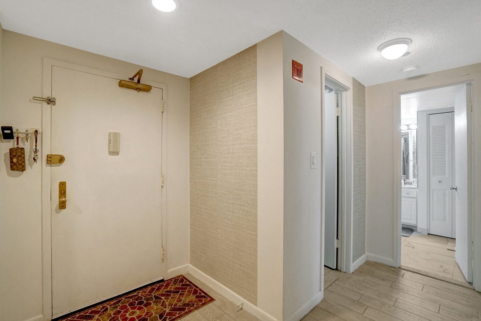 Entry foyer with tile flooring and view down the hallway