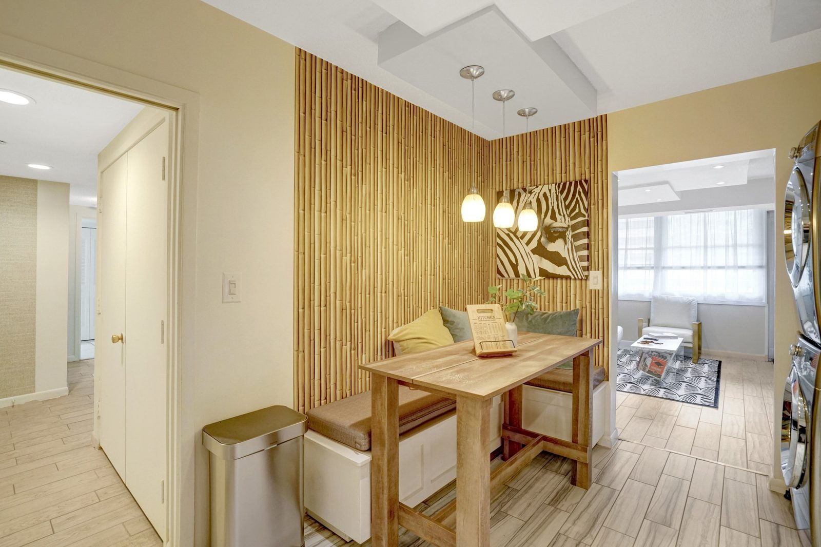 Breakfast nook with bamboo accent wall, pendant lights and bench seating