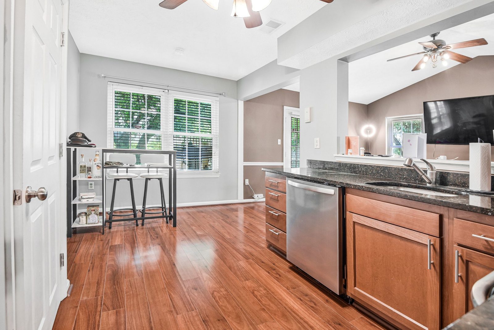 Kitchen sink and dishwasher with bar-height table beside window