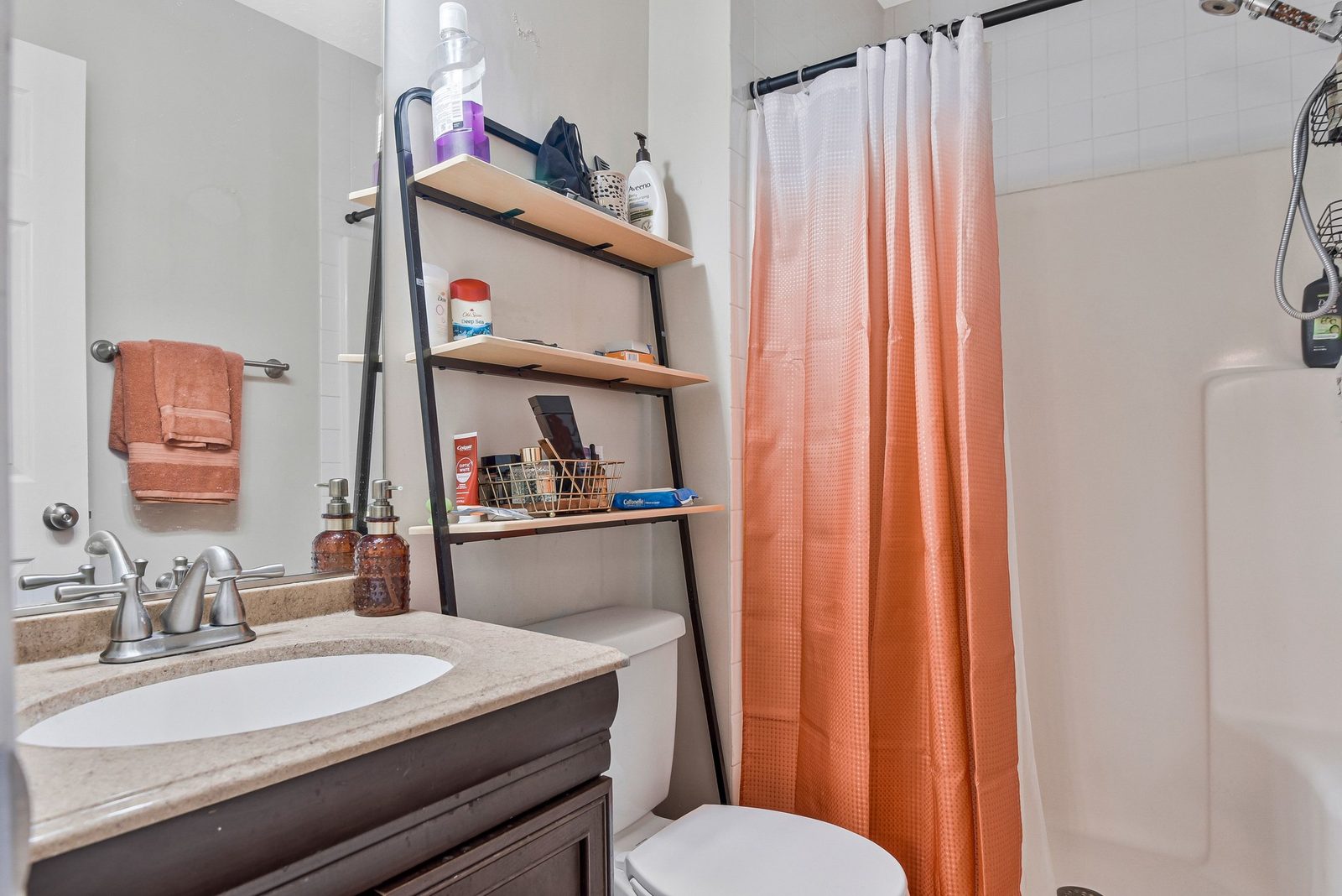 Full bathroom with stone-look vanity top and curtained shower