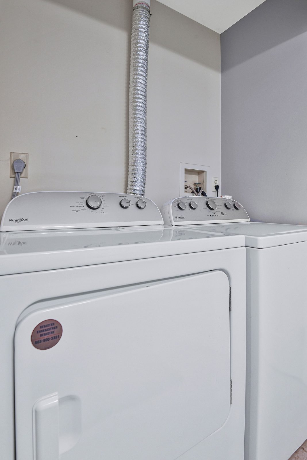 Top-load washer and dryer in laundry alcove with vent duct
