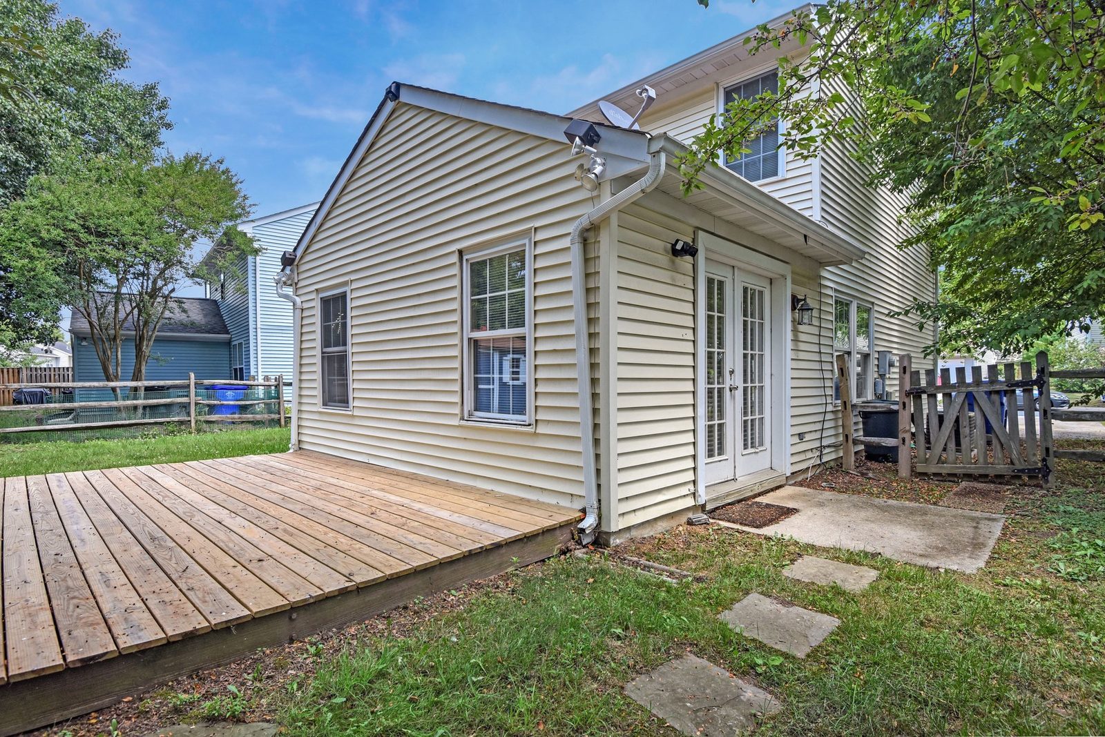 Rear entry with French doors, wood deck and concrete pad