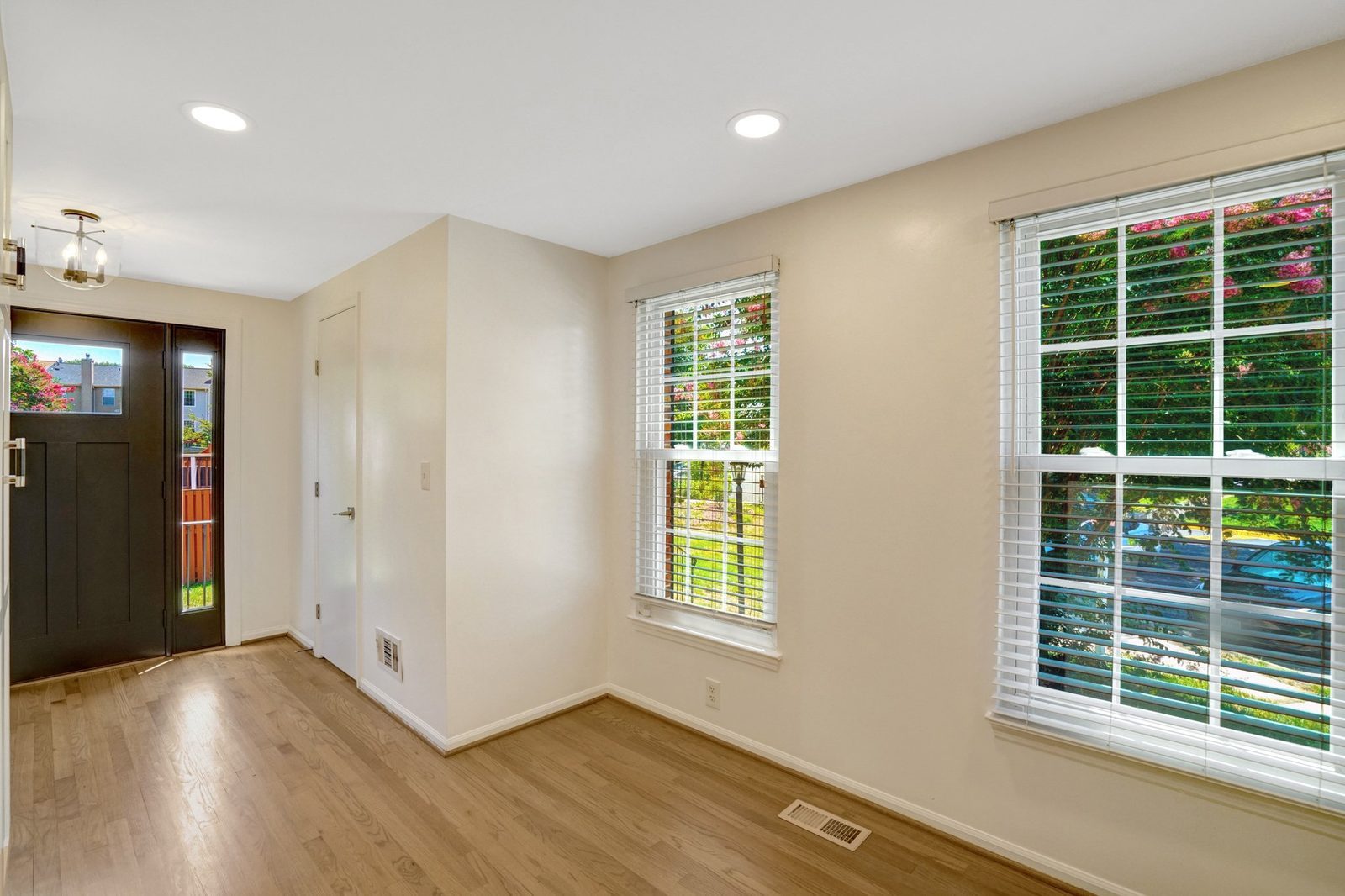 Room off the front entry with hardwood floors and two windows
