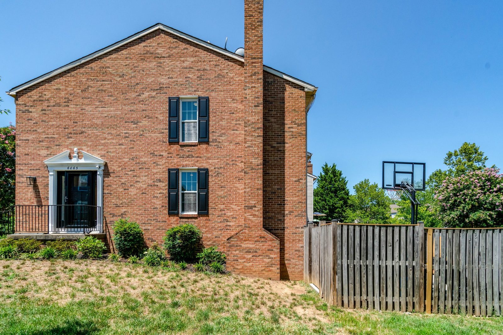 Front elevation of brick townhouse with white columned entry portico