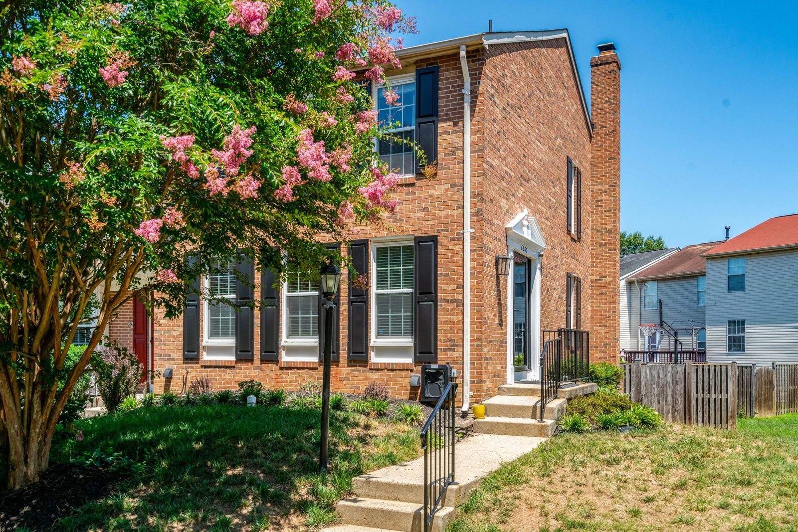 Front exterior with blooming crape myrtle, lamp post and entry steps
