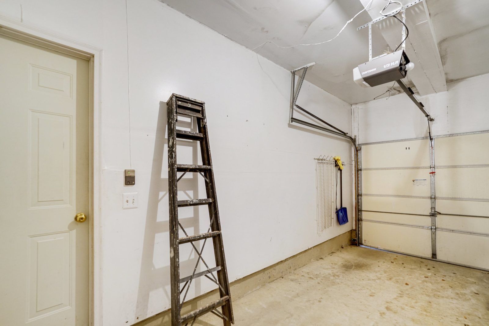 Garage interior with concrete floor and overhead door opener